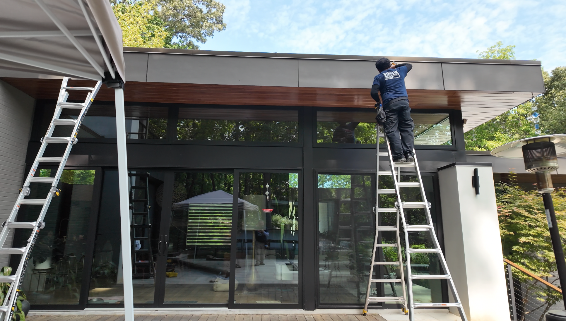 Aurora professional installation team working on a custom retractable shade project at a modern Georgia home